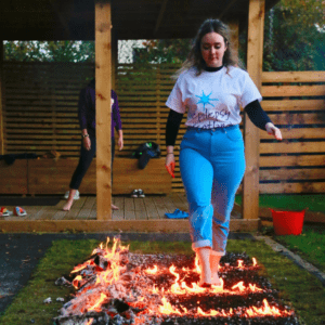 Woman walking over hot coals