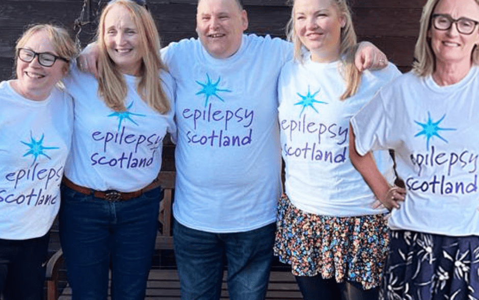 Four woman and a man wearing Epilepsy Scotland t-shirts