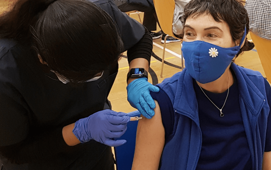 A woman getting the COVID vaccine